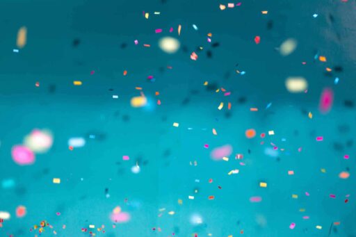 green, teal background with confetti falling