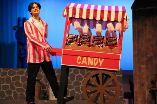 Actor in striped blazer with candy cart