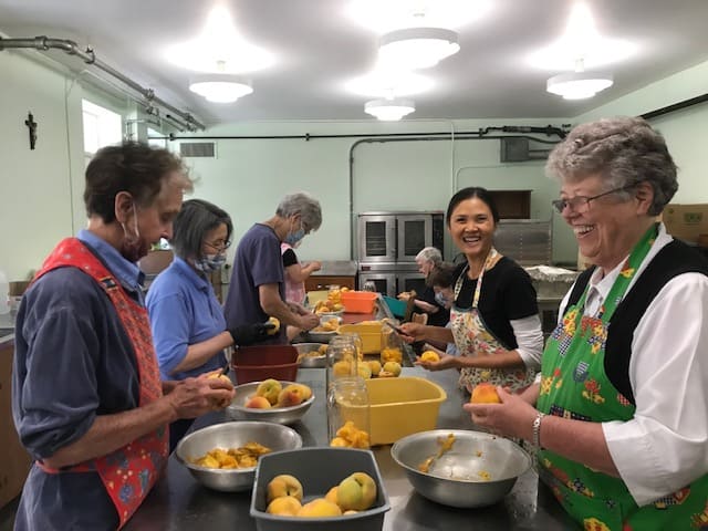 Sisters prepare a meal for Catholic Charities