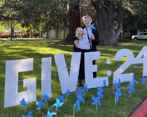 Sister Adele Marie Altenhofen with "Give 24" cutout yard sign