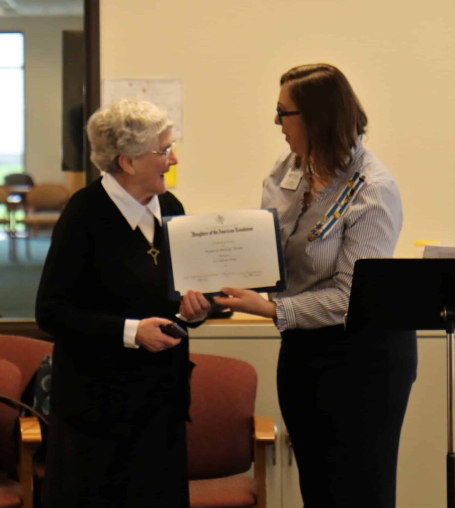 Sister Catherine receives award from Lynn Daue