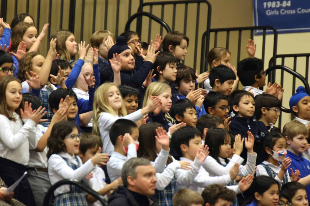 Joyful students on gym bleacher stands
