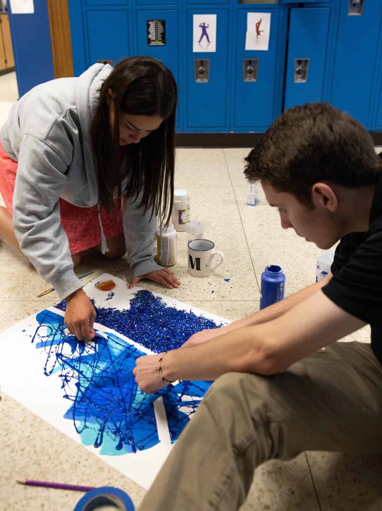 Seniors using glitter, rhinestones and paint for Mr Valiant