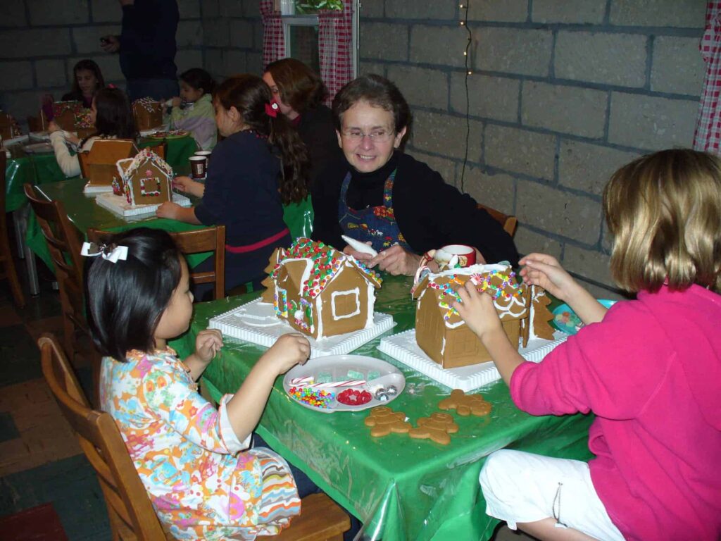 Sr. Barbara Rose helping children make ginger bread houses