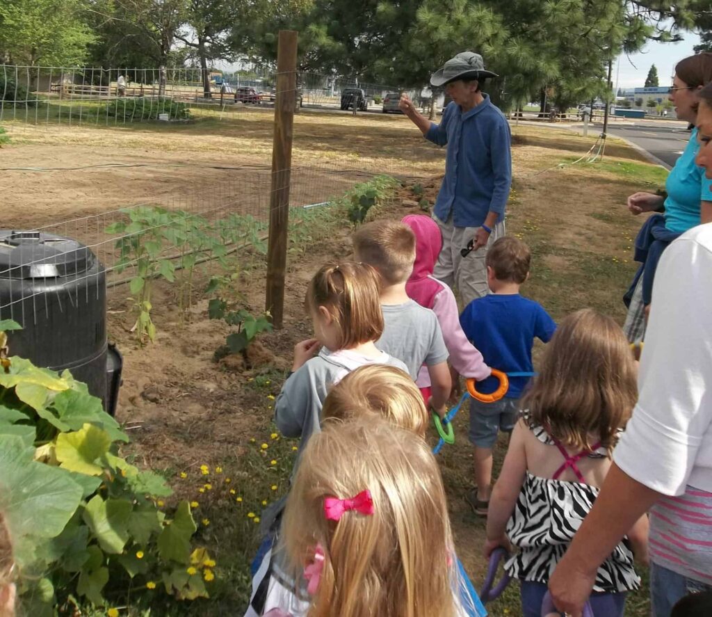 Sr. Barbara Rose teaching children about composting