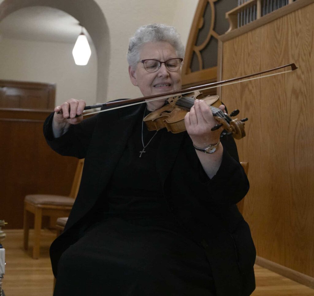 Sr. Denise playing violin