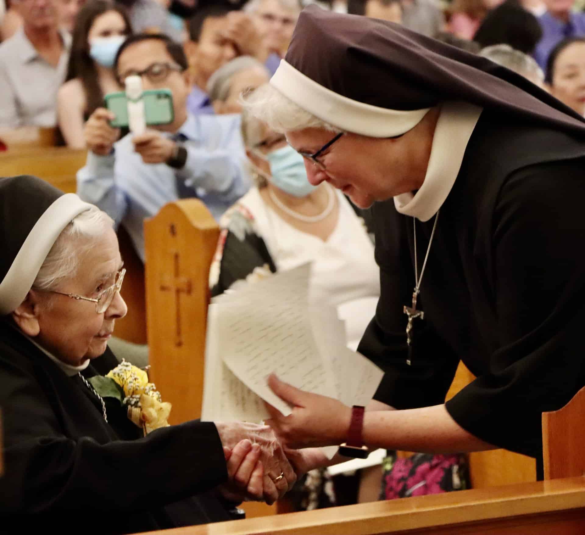 Sister Michael Francine Duncan, SSMO Superior General, congratulates Sister Clare Vandercoevering on her 75th Jubilee