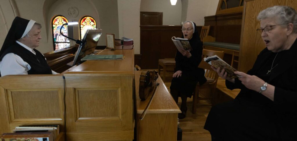 Srs. Juliana, John Therese, and Denise enjoying playing music and singing in the Motherhouse Chapel