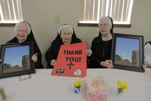 The Vandecoevering Sisters with a Thank You sign