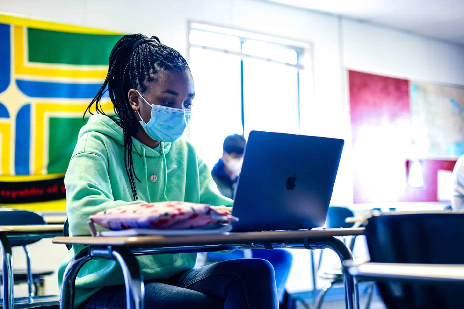 In class at Valley Catholic High School; student at desk on laptop