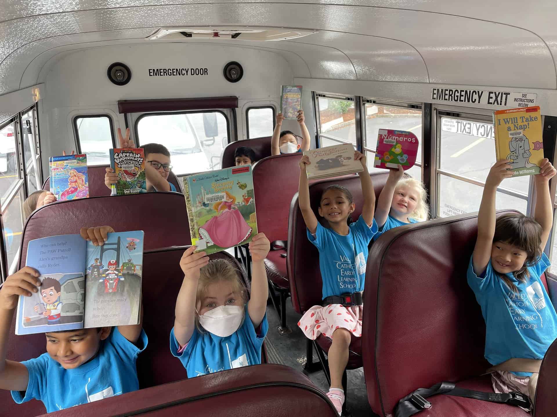 Early Learning School students with books on field trip
