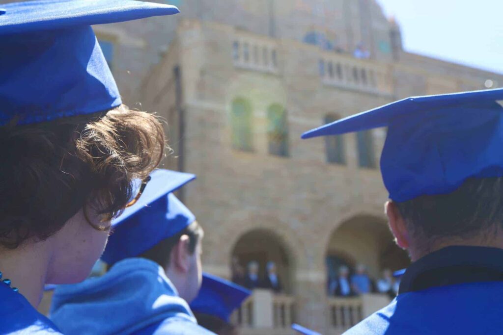 Close up of graduates in front of mother house