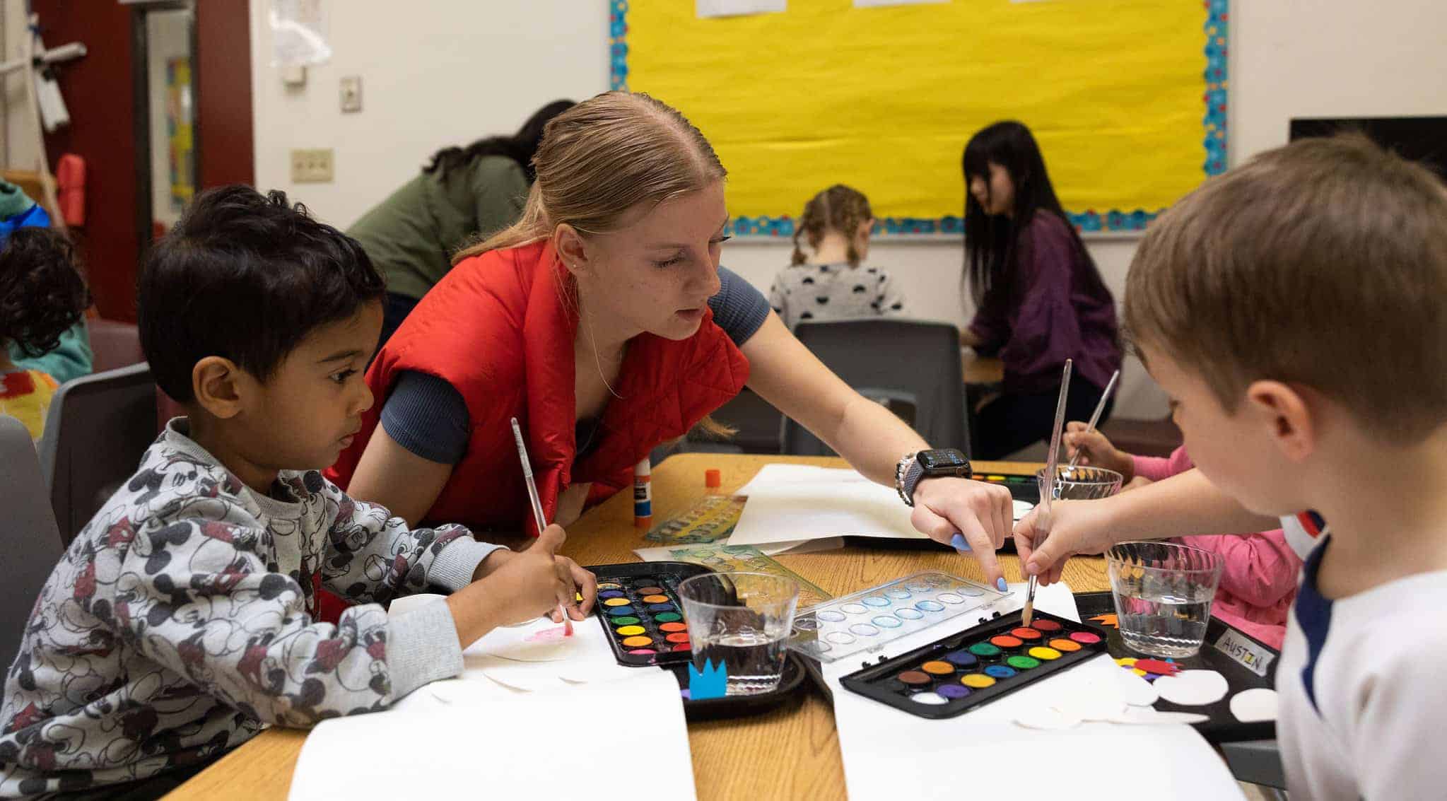 High school and early learning students creating art together