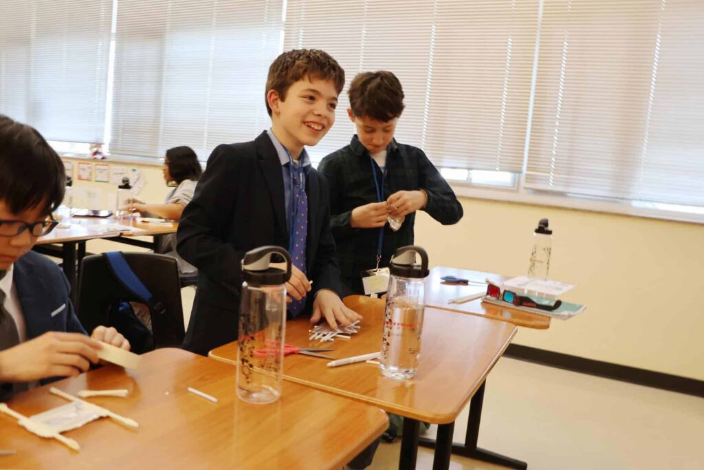Middle school boys at desk working on STEM projects