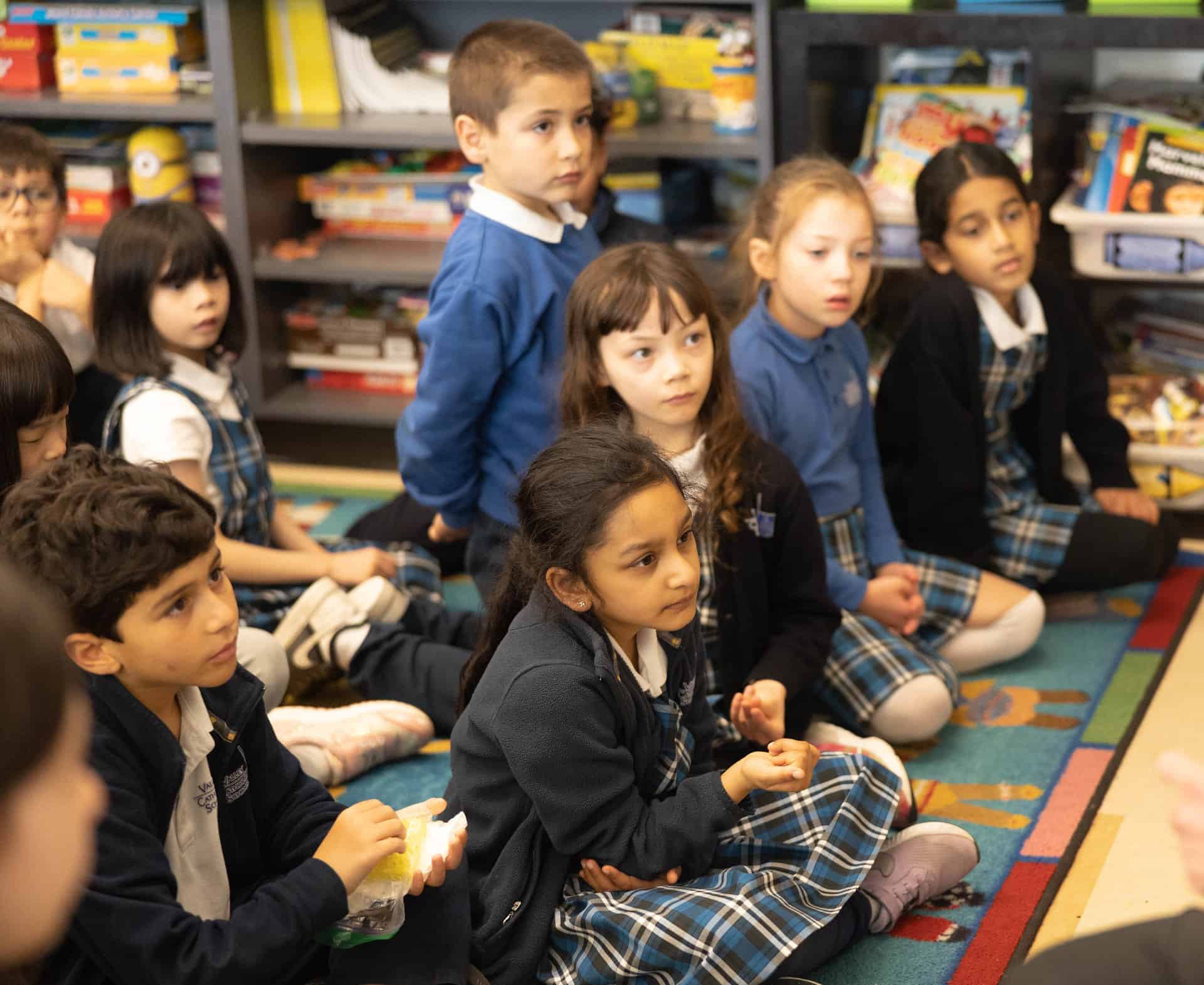 Second graders on the mat, in the library