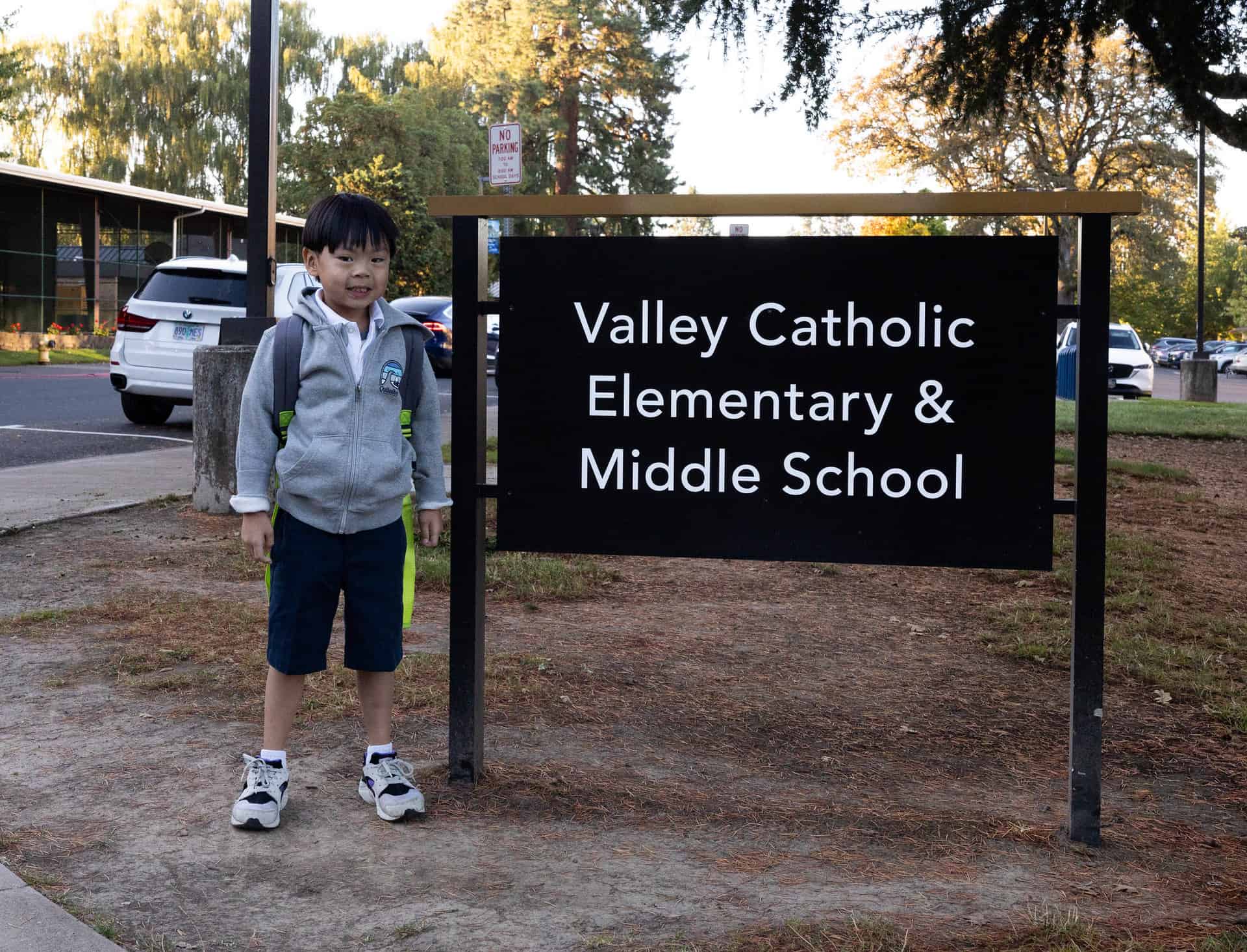Elementary school student by sign