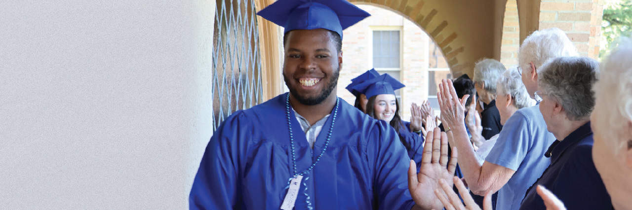 Students walking corridor; high-fiving Sisters