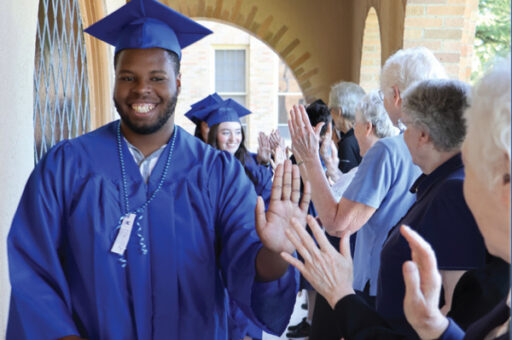 Graduates high-fiving Sisters