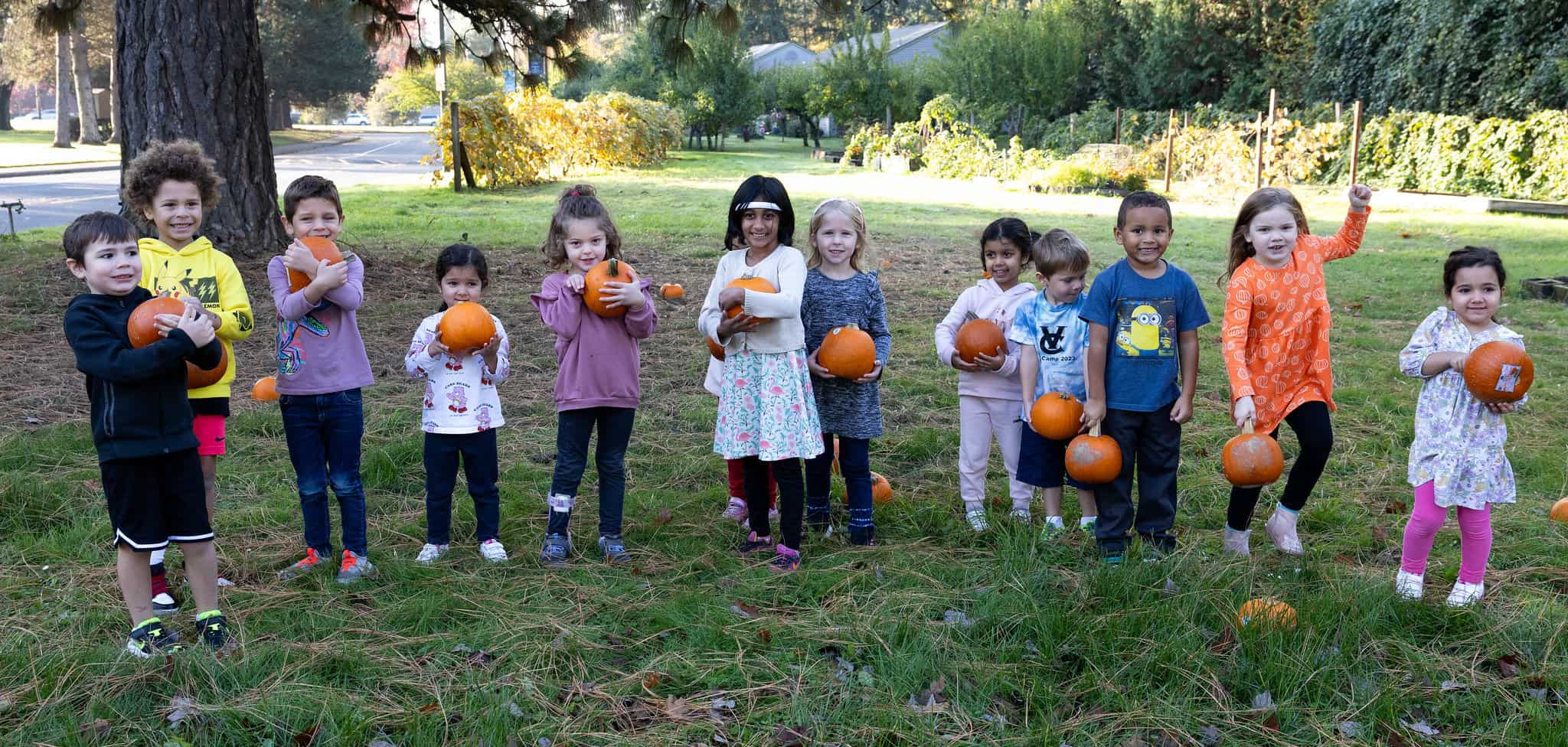 Little kids with pumpkins