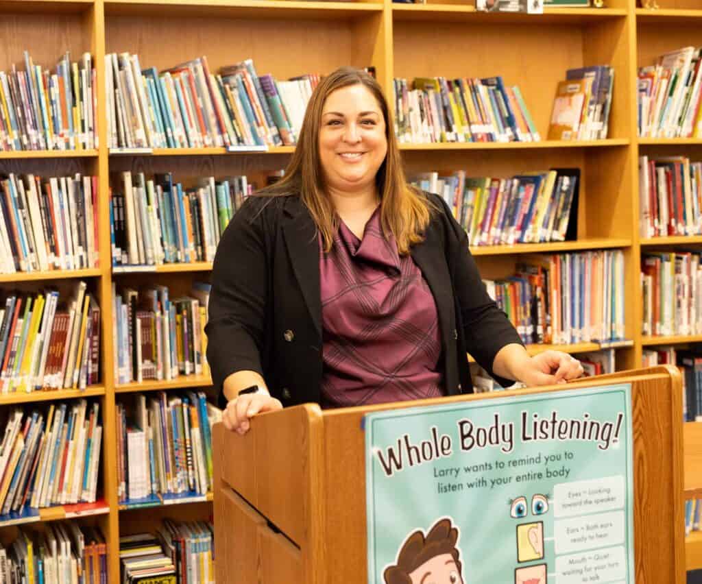 Amber Ploussard, V C E L S Principal, behind a podium