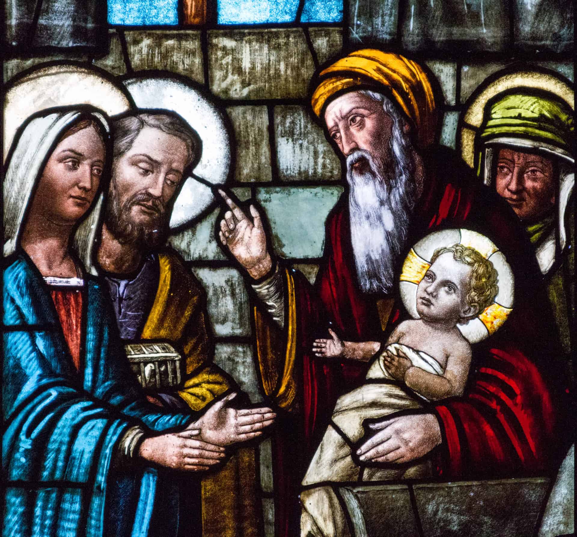 A stained glass window depicting Feast of the Presentation of Our Lord Jesus and the the Purification of the Blessed Virgin Mary