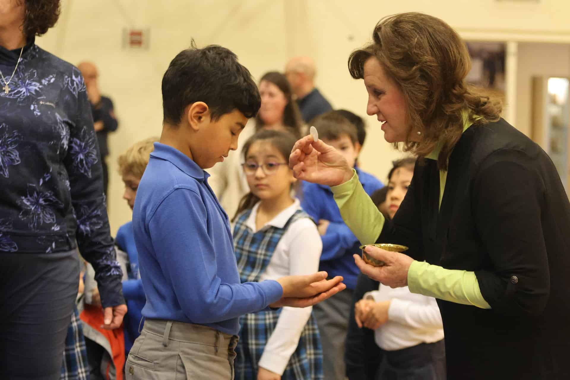 Teacher and student participating in Mass