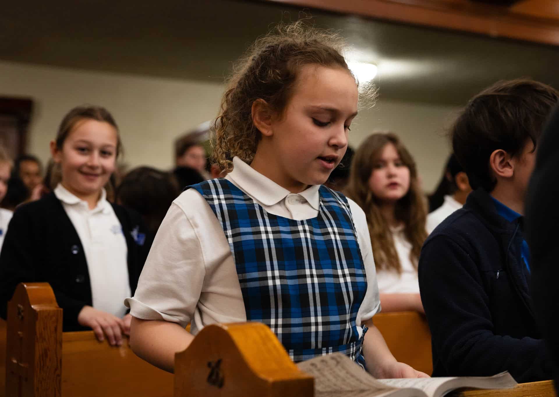 Students singing during mass