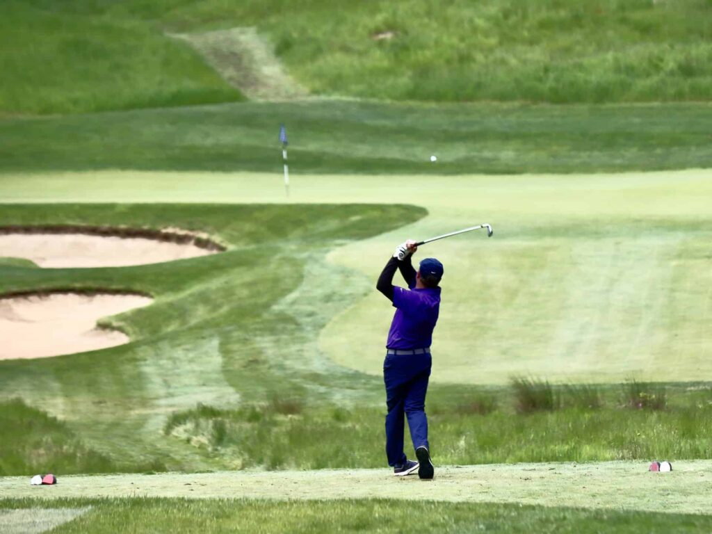 Harvey follows through golf