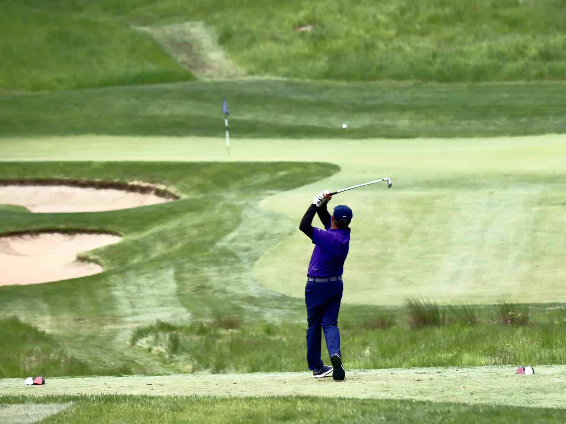 Harvey follows through golf