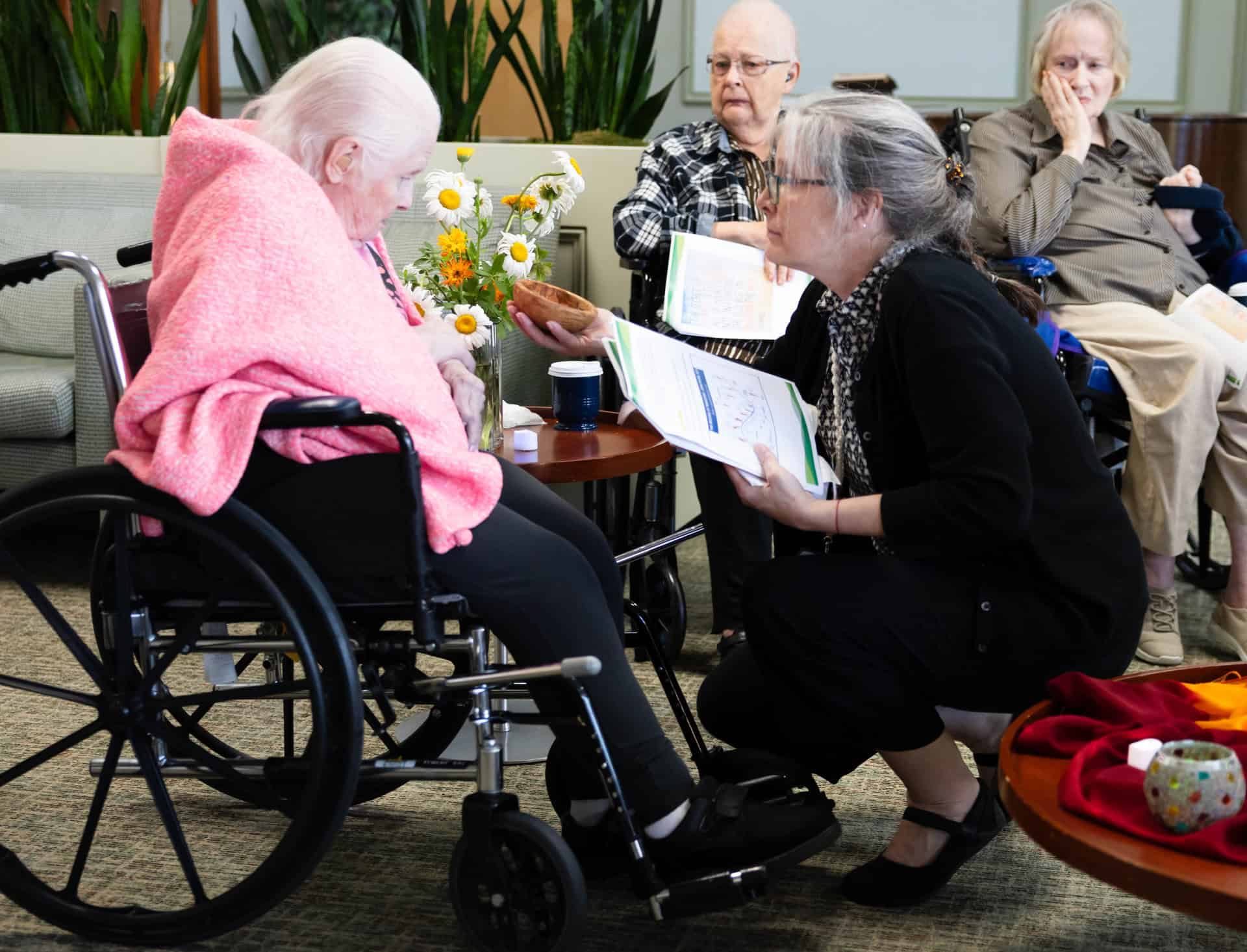 Melissa McCoy passing the olive wood bowl to a maryville resident during women's group