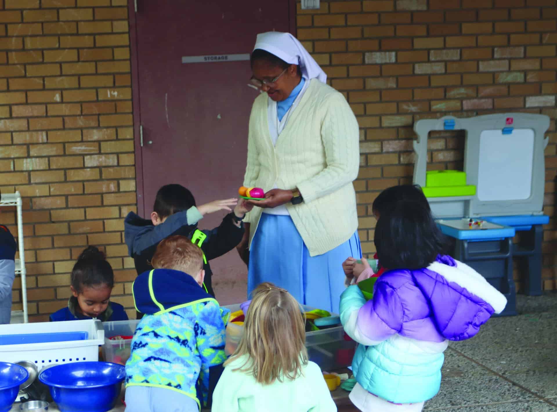 Sister Mary Kimario, preschool teacher, with her students