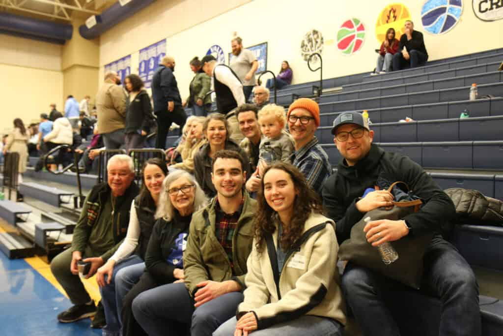 Alumni family enjoying basketball game