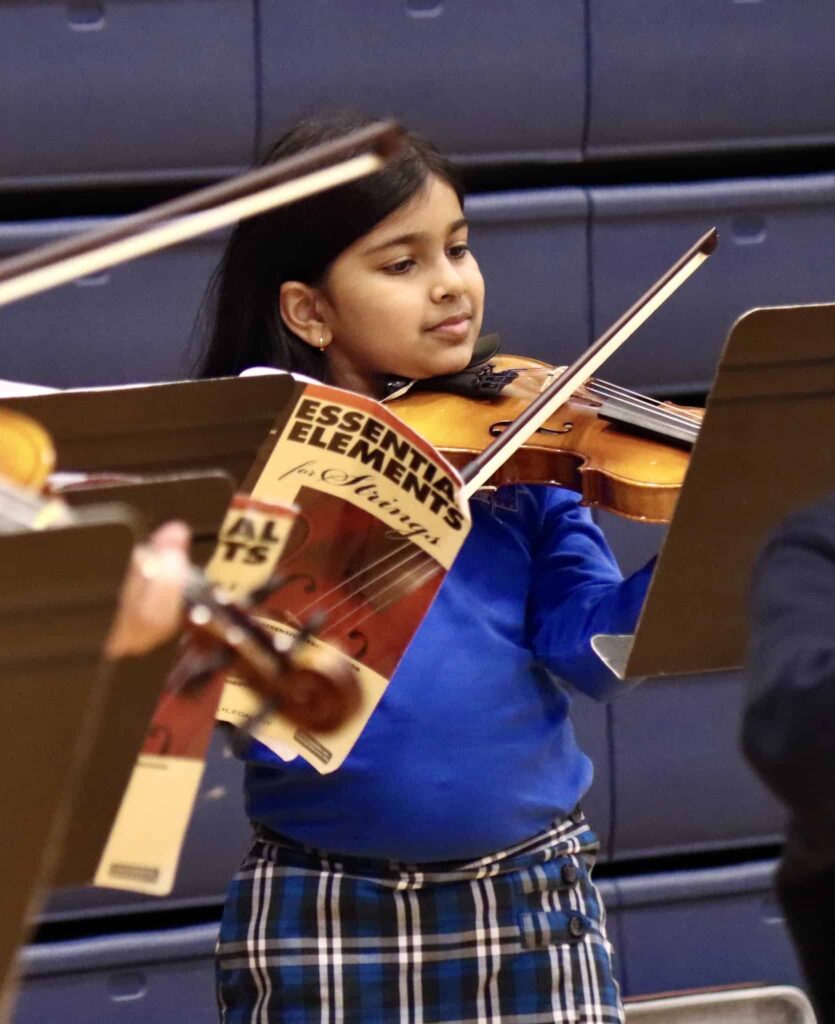 student plays violin at Grandparents Day