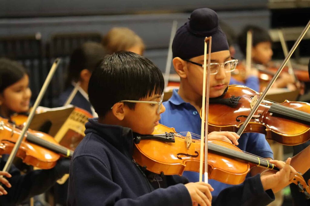 VCES students play violin at Grandparents Day