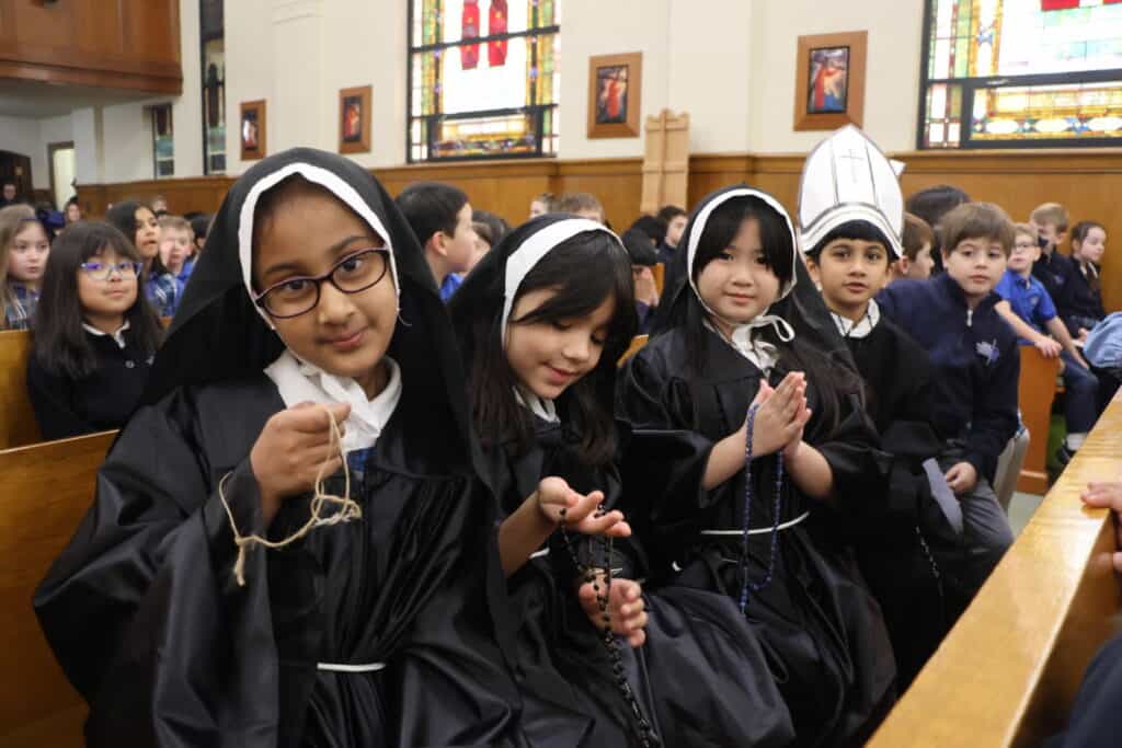 VCES students dress as religious sisters and priests at Heritage Days Prayer Service