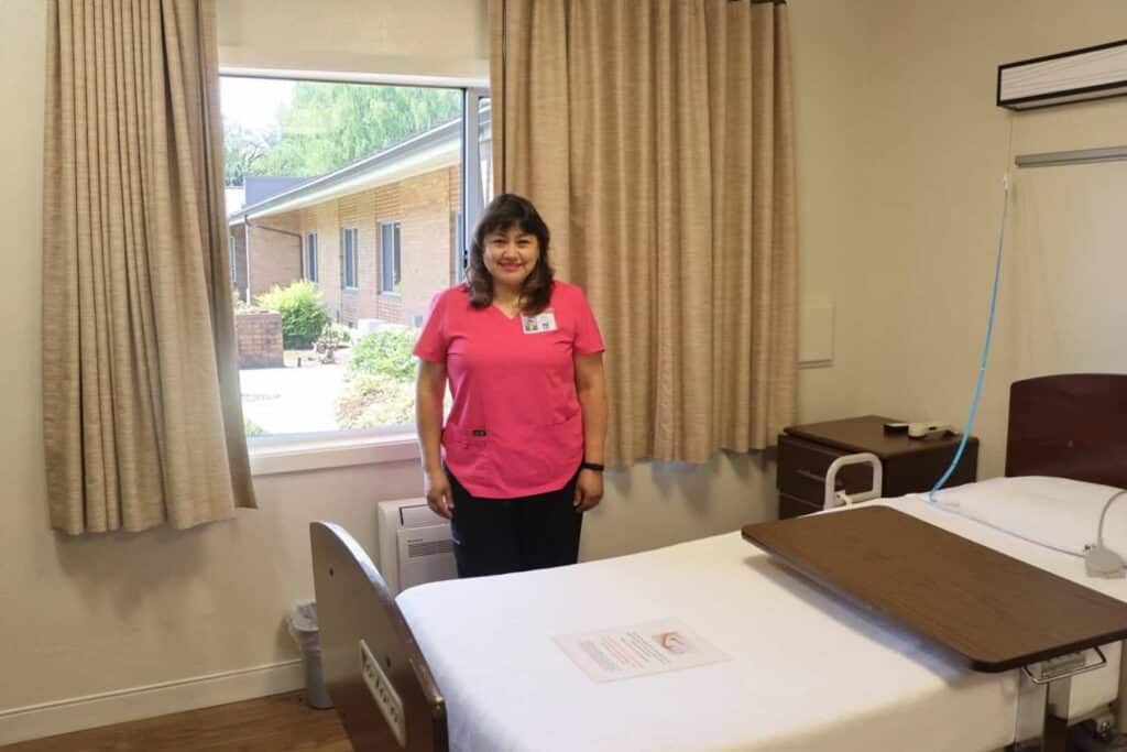 Maribelle Garcia in a renovated room at Maryville