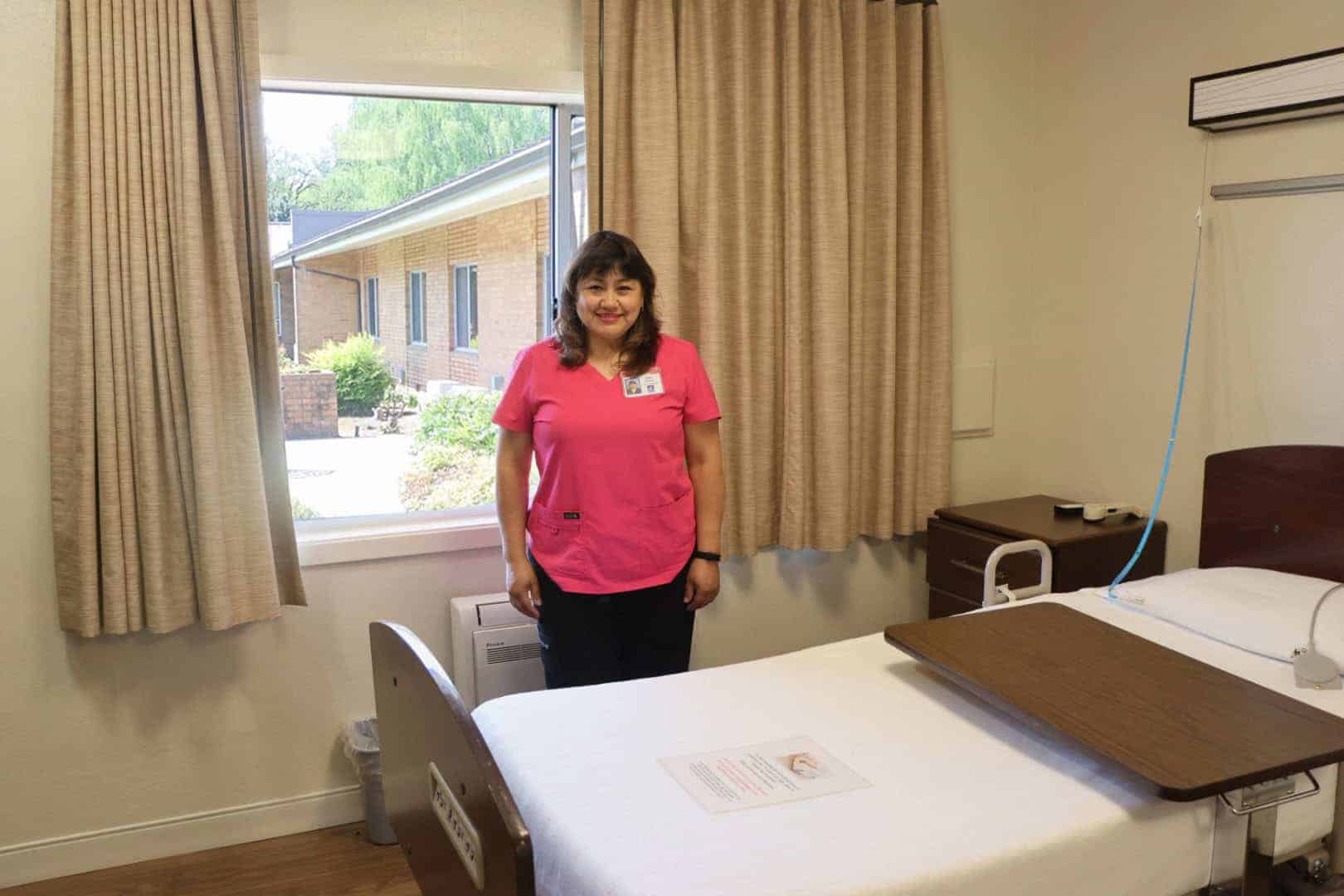 Maribelle Garcia in a renovated room at Maryville