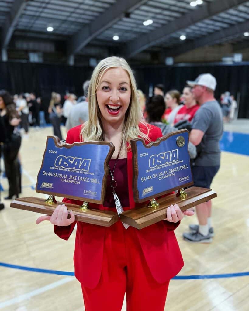 Meghan hoffman holding state dance trophies