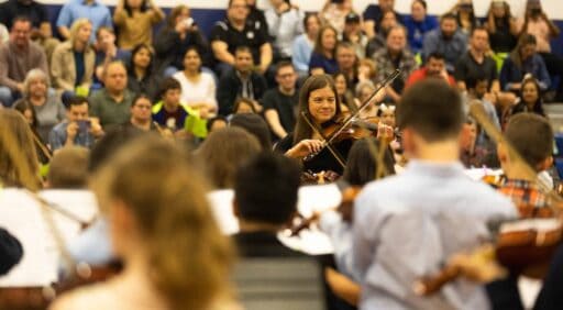 Emily Pockat directs VCES violinsts at Christmas Concert