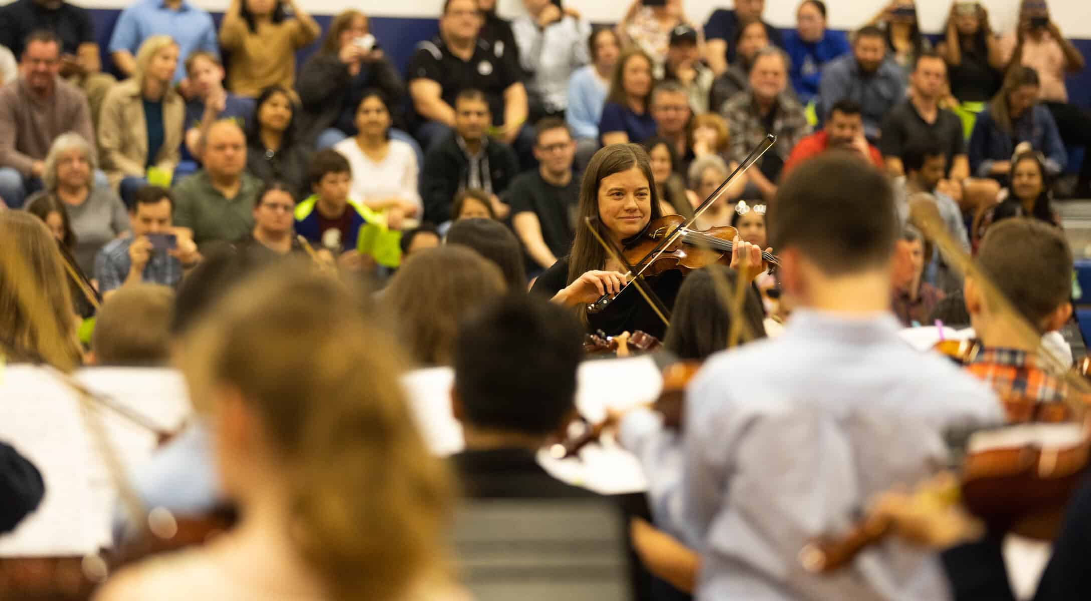 Emily Pockat directs VCES violinsts at Christmas Concert