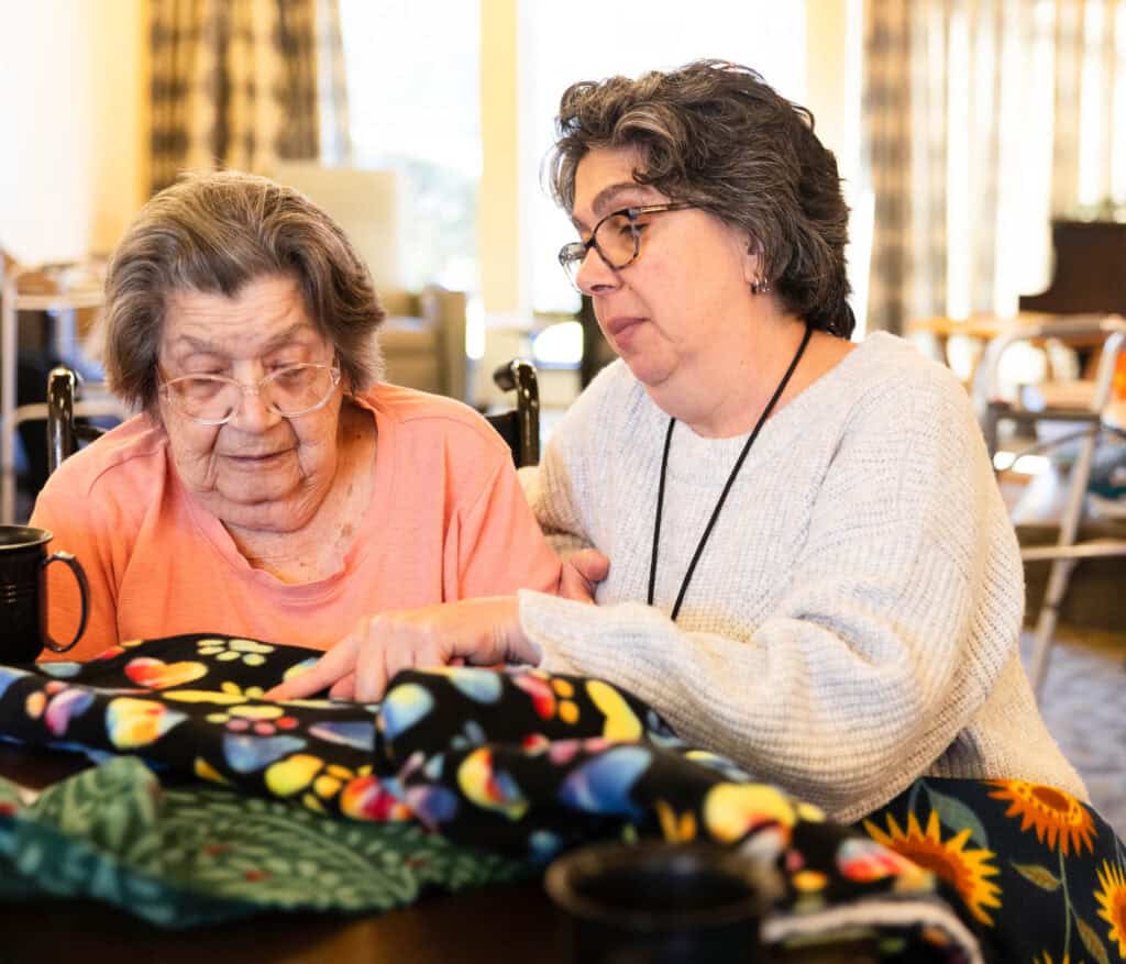 Kristi Rogers helps make quilts at maryville memory care