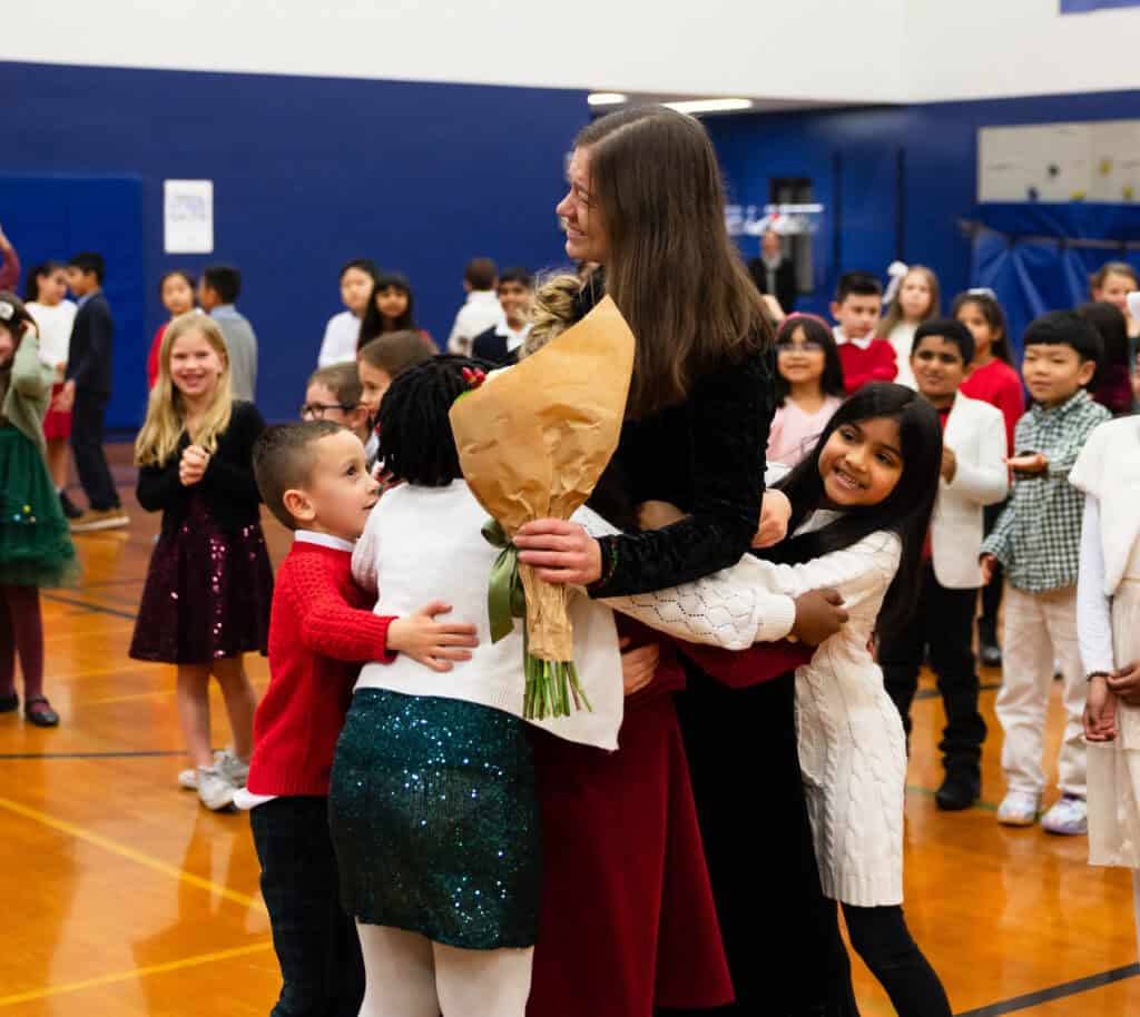 Emily Pockat being congratulated by her students