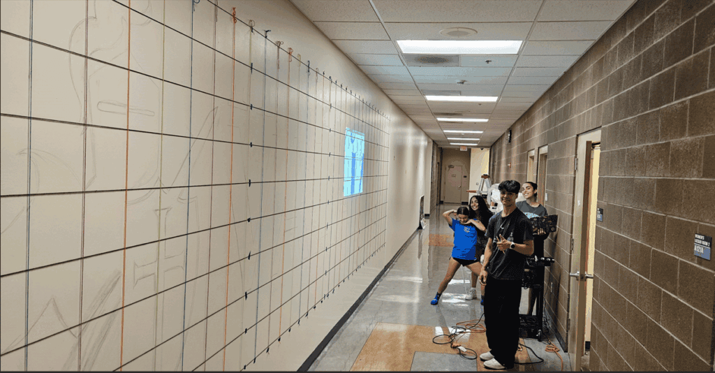 Valiants mural blocked out in grid on gym wall