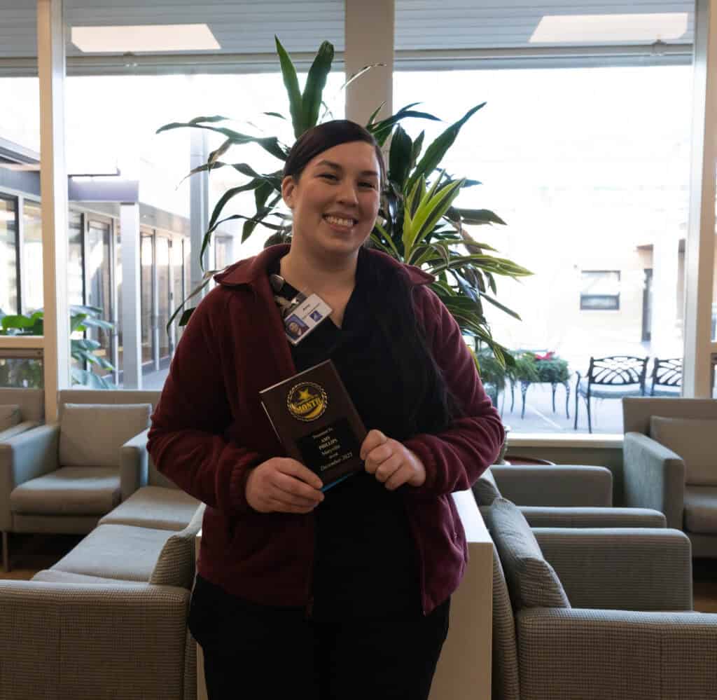 Maryville's Amy Phillips holding her employee of the month plaque.