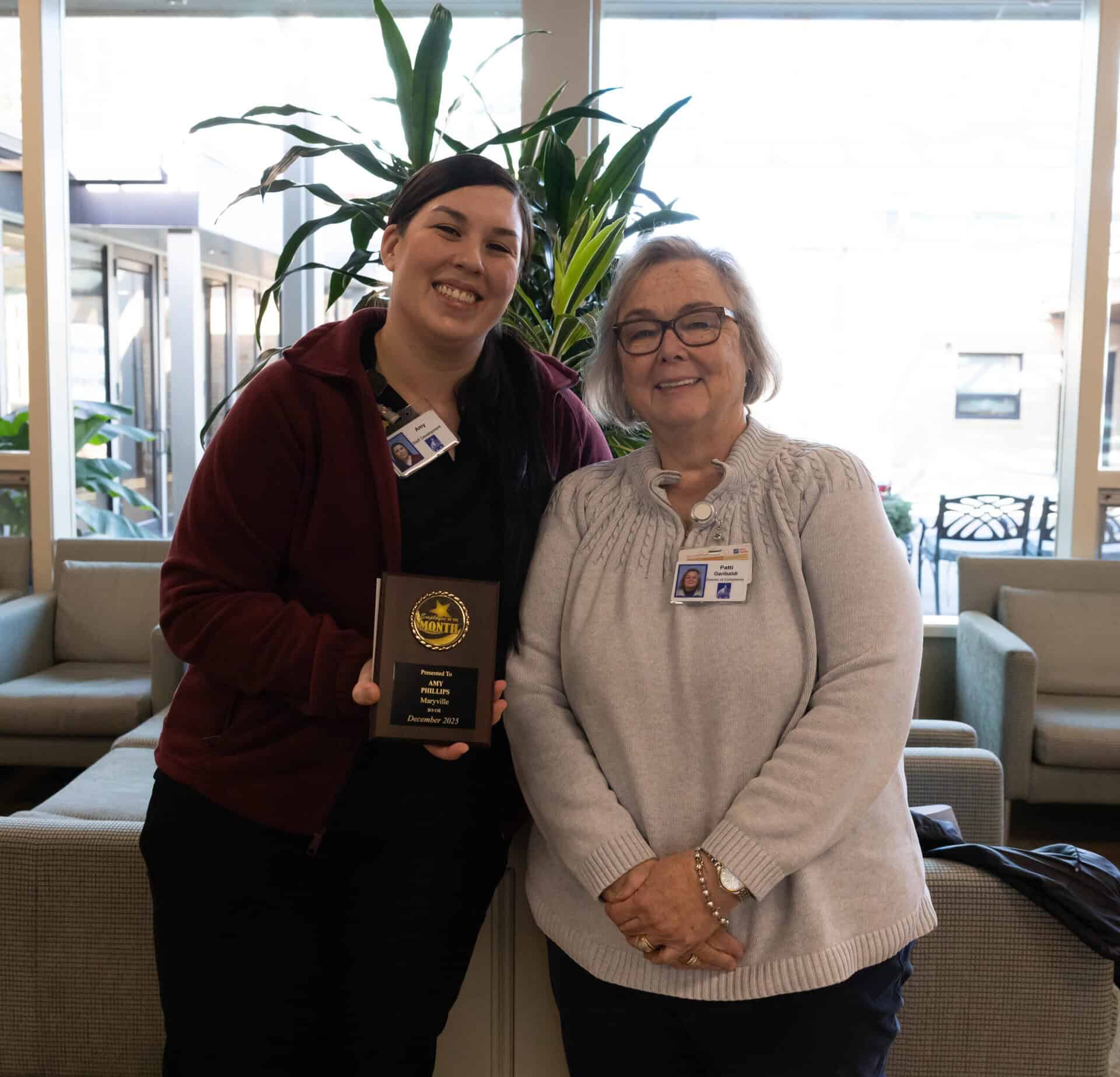 Maryville's Amy Phillips and Patti Garibaldi are all smiles at Amy's employee of the month ceremony.