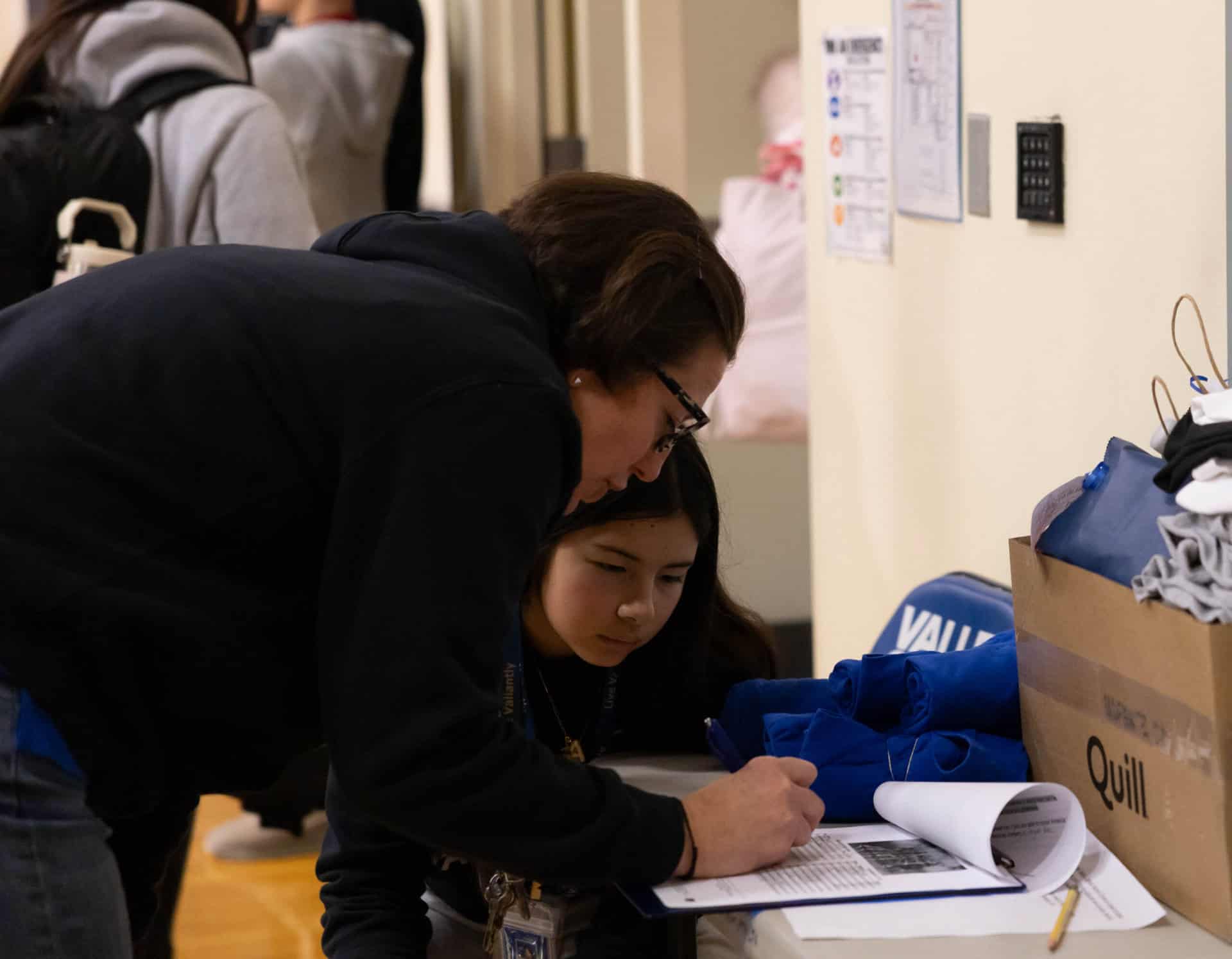 Athletic Director, K.T. and director for the day Avery M. prepping for the game