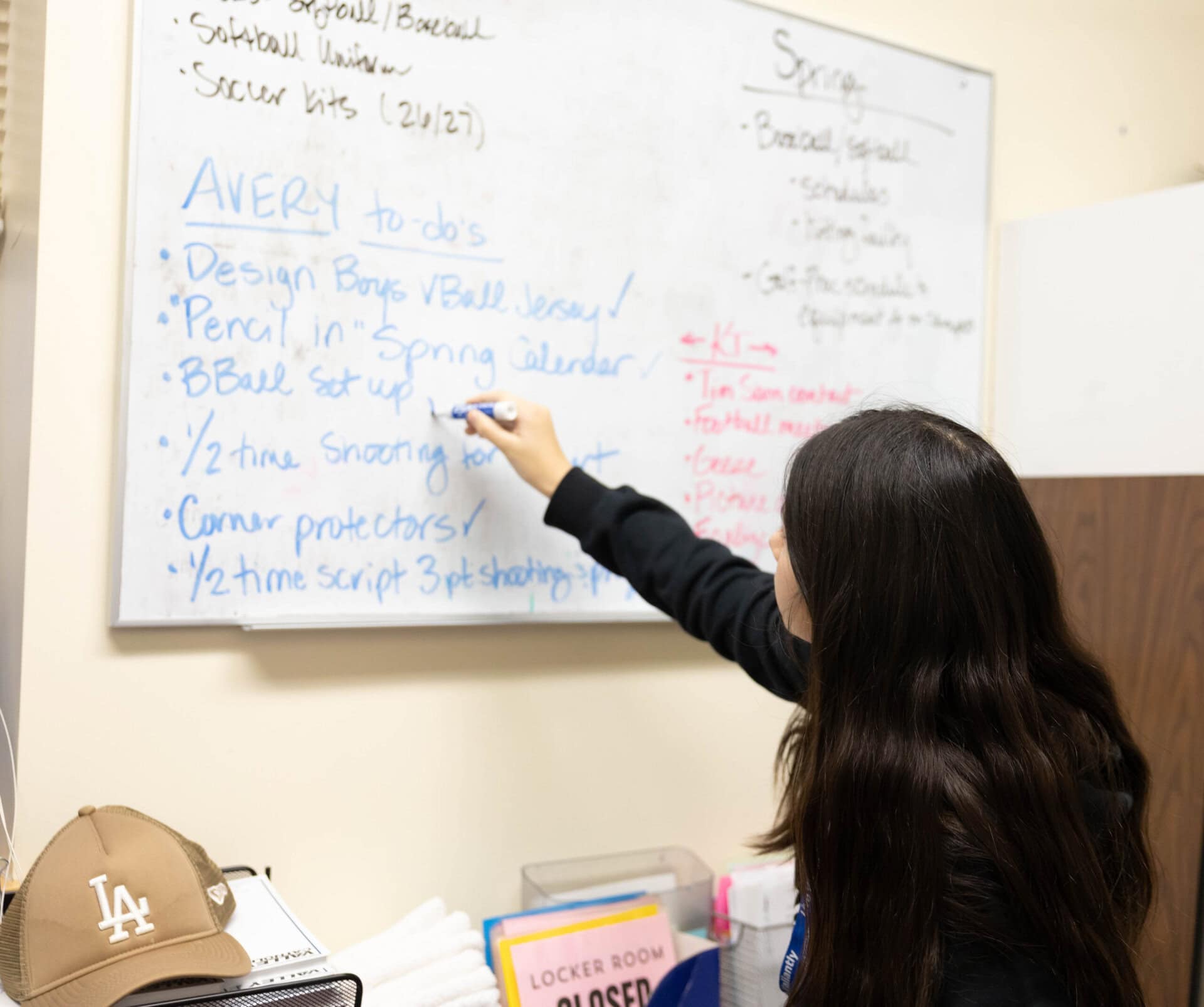 Avery M at white board checking off items completed