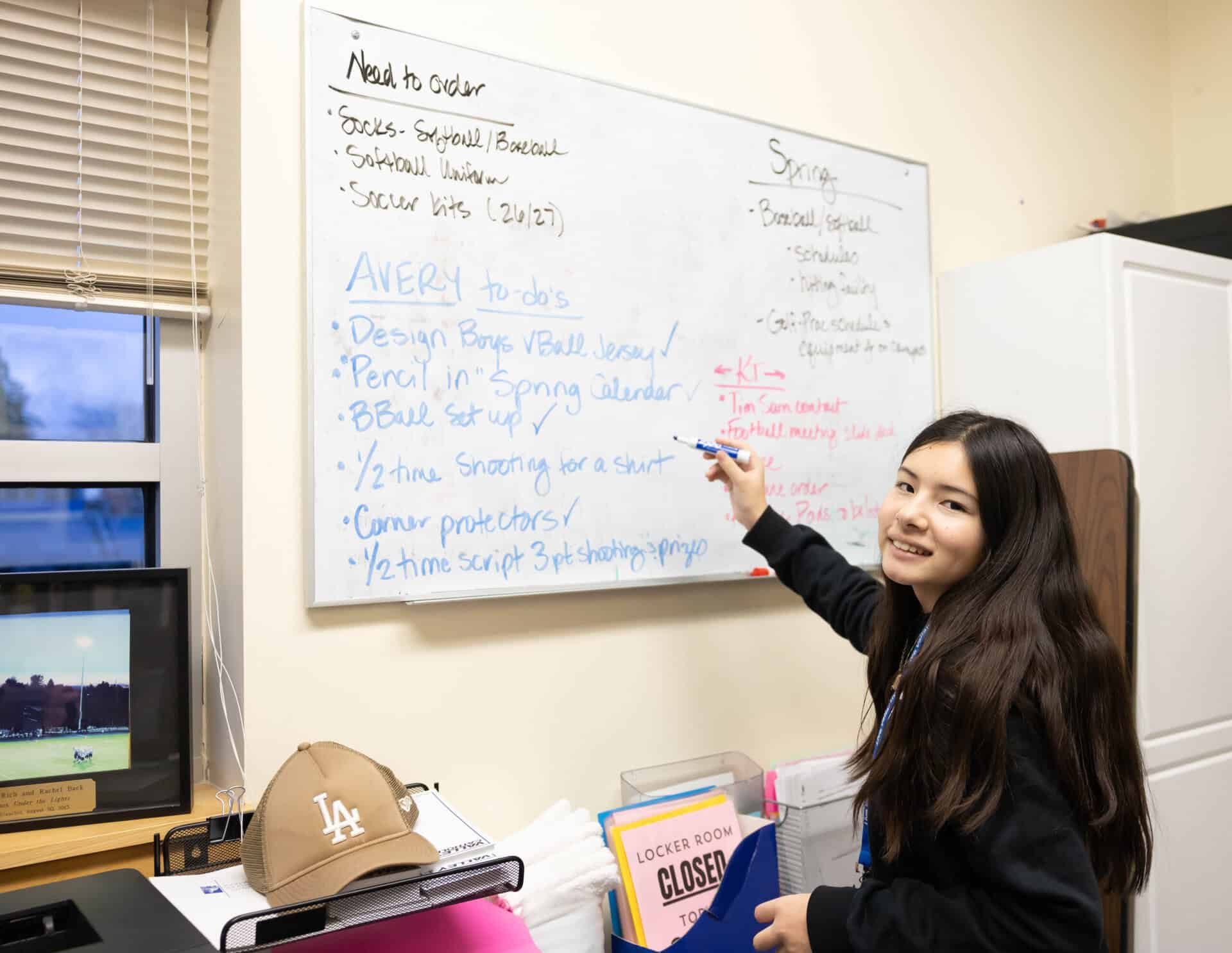 Avery M at white board getting prepared for games