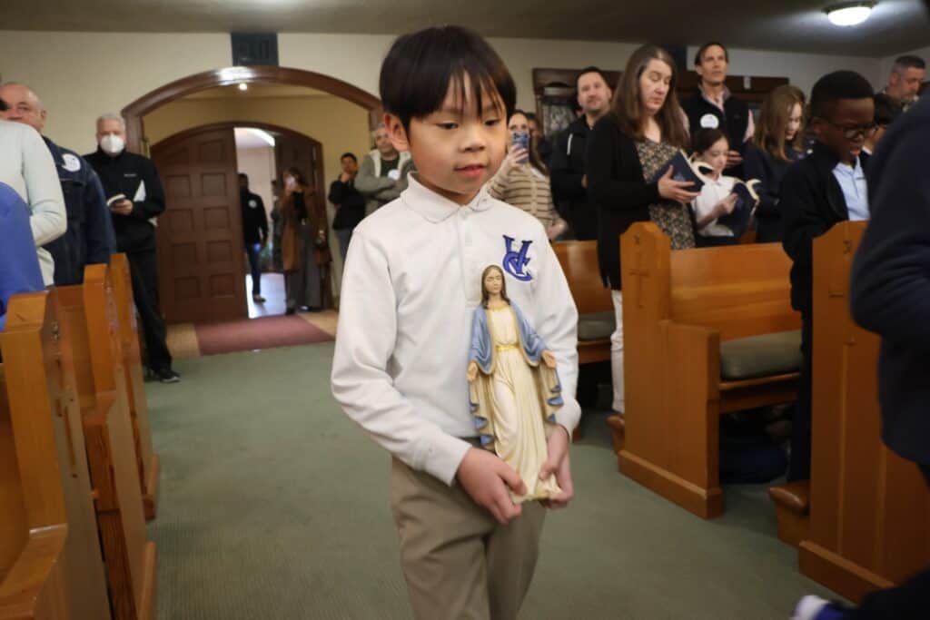 Student lead prayer service at heritage mass
