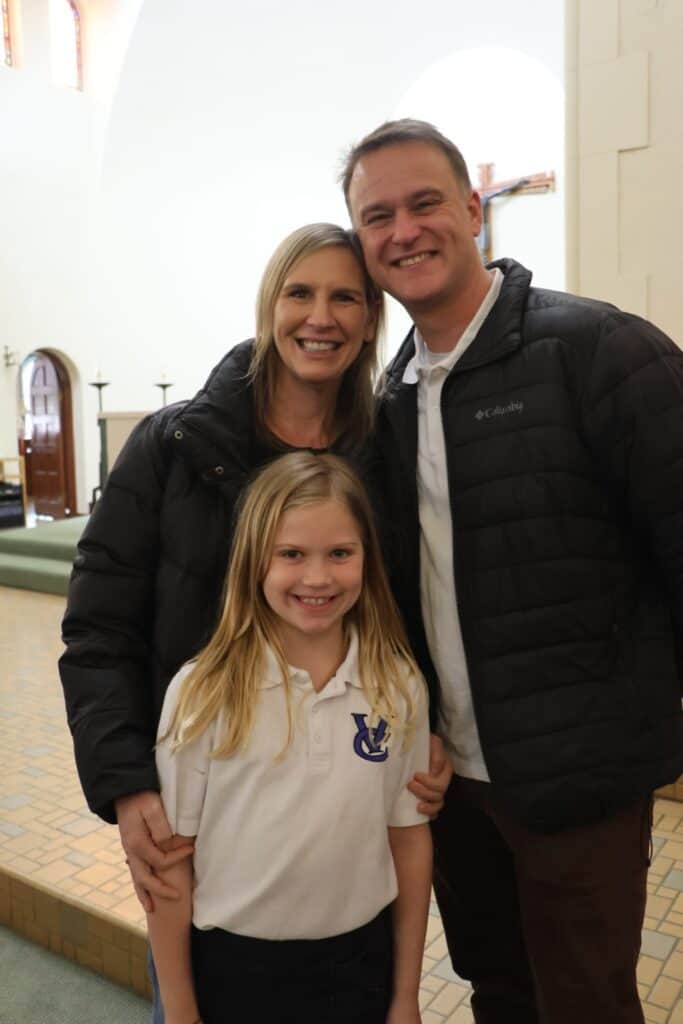 VCES Hertiage Mass candid photo with student and parents